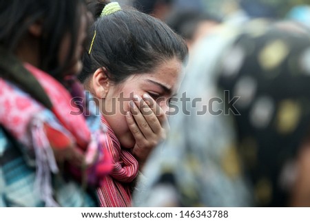 VAN, TURKEY - OCTOBER 25: Young Turkish girl crying in front of his house for own family on October 25, 2011 in Van, Turkey. It is 604 killed and 4152 injured in Van Earthquake.