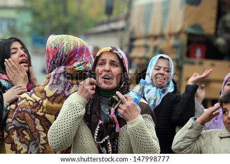 VAN, TURKEY - OCTOBER 25: Turkish women crying in front of his house for own family on October 25, 2011 in Van, Turkey. It is 604 killed and 4152 injured in Van Earthquake.