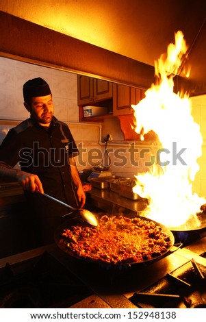 ISTANBUL, TURKEY - JUNE 14: A chef cooking traditional Turkish food \'Sac kebab\' on June 14, 2012 in Istanbul, Turkey.
