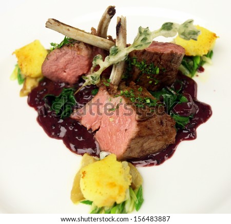 Lamb chops with potato and blackberry sauce on the dinner plate in Istanbul, Turkey.