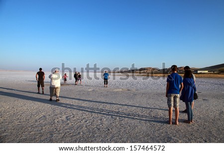 SALT LAKE, TURKEY - AUGUST 23: People walking at Salt Lake on August 23, 2013 in Aksaray, Turkey. Salt Lake is the second largest lake in Turkey with its 1665 km2.