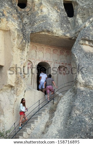 CAPPADOCIA, TURKEY - AUGUST 24: Tourists visiting Cave Church at Goreme on September 24, 2013 in Nevsehir, Turkey. Cappadocia is part of the UNESCO World Heritage Site.