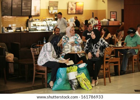 ISTANBUL, TURKEY - JULY 14: Arab tourists drinking coffee after shopping at shopping mall on July 14, 2011 in Istanbul, Turkey.