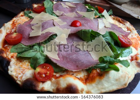 Meat pizza on the dinner plate.