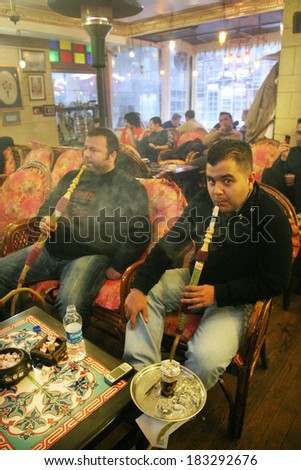 ISTANBUL, TURKEY - JANUARY 5: Turkish people smoke hookah (Nargile) in cafe on January 5, 2008 in Istanbul, Turkey. Nargile became part of Turkish culture from the 17th century.