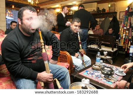 ISTANBUL, TURKEY - JANUARY 5: Turkish people smoke hookah (Nargile) in cafe on January 5, 2008 in Istanbul, Turkey. Nargile became part of Turkish culture from the 17th century.