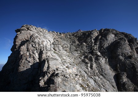 Summit of Mount Olympus. Mount Olympus is highest mountain in Greece at 2917 meters. Peak name is Mytikas. (Mount Olympus is the home of the Twelve Olympians, the principal gods in the Greek pantheon)