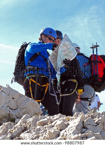 BAVARIA, GERMANY - SEPTEMBER 21: Climbers, talking to return route on the map in top of the Mount Alpspitze, September 21, 2010 in Bavaria, Germany. Alpspitze is the second highest mountain in Germany