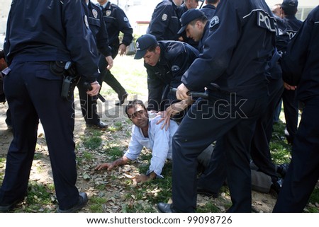 ISTANBUL, TURKEY - MAY 1: International Workers Day. Turkish Police Officers detain a protester on May 1, 2008 in Istanbul, Turkey. Taksim Square is the center of the protest and celebrations.