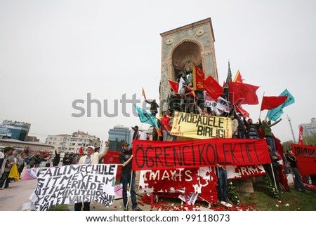ISTANBUL, TURKEY - MAY 1: International Workers Day. Workers and socialist group climbing Taksim Republic Monument on May 1, 2009 in Istanbul, Turkey. Taksim Square is the center of the celebrations.