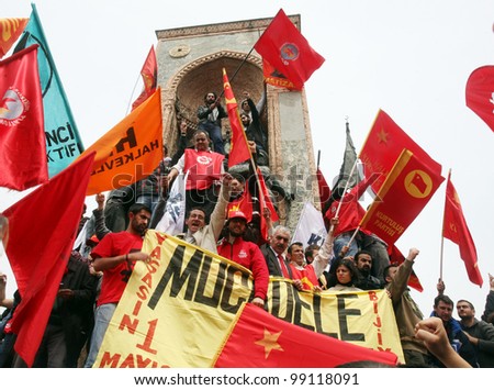ISTANBUL, TURKEY - MAY 1: International Workers Day. Workers and socialist group climbing Taksim Republic Monument on May 1, 2009 in Istanbul, Turkey. Taksim Square is the center of the celebrations.