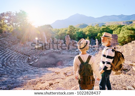Travel and tourism. Senior family couple enjoying view together on ancient amphitheatre.