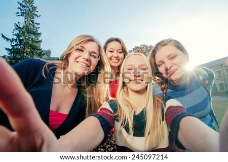 Capturing fun. Student\'s life. Four young happy women making selfie and smiling outdoors.