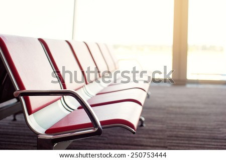 Bench in the terminal of airport. empty airport terminal waiting area with chairs.
