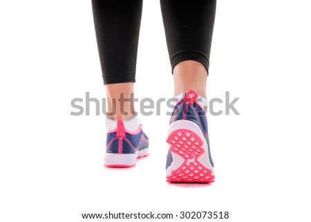 Sport and fitness. Close up of female feet with snickers. Isolated on white,