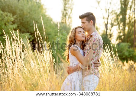 Love and romance. Outdoor portrait of beautiful loving couple embracing in park.