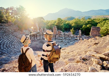 Travel and tourism. Senior family couple enjoying view together on ancient amphitheater.