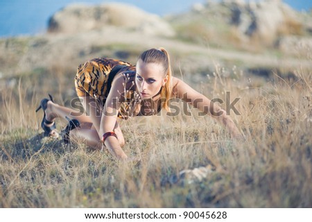 beautiful girl in panther texture yellow dress posing on the ground
