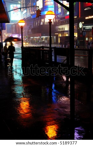 New York Time Square street scene in the rain at night