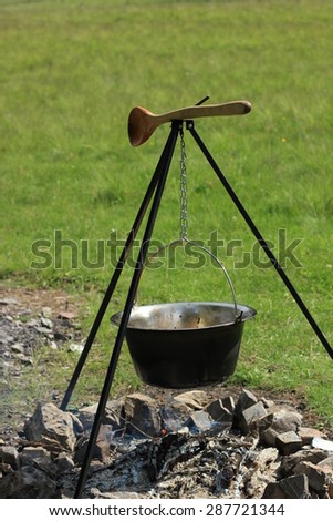 Outdoor cooking in cauldron