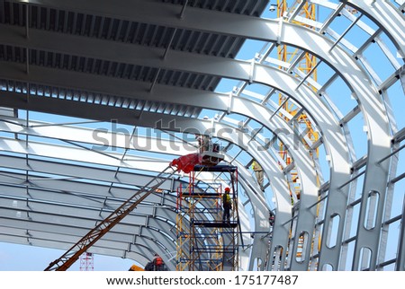 Airport construction in the middle stage. Frame, construction, design. The metal structure. To build a building. Industrial. The construction of the airport terminal. The construction works.