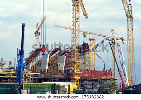 Industrial construction with a lot of cranes and building equipment