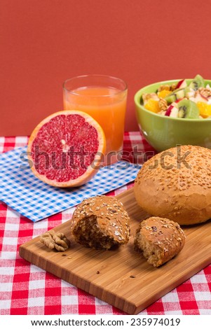Bread on a wooden board. Healthy and nutritious vegetarian breakfast. Fitness products for weight loss. Concept of healthy food and diet. Fruit salad and bread.