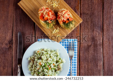 Risotto, bruschetta and cutlery on the table. Italian cuisine. Delicious European cuisine. Cooking, hobbies. Rice with vegetables on the plate. Top view