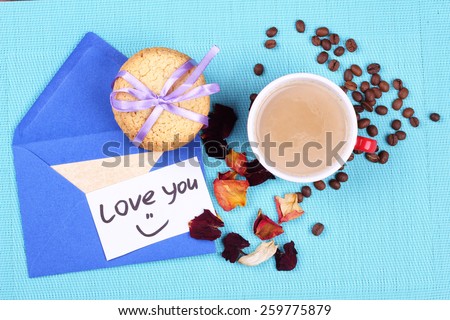 Cookies, cup of latte, letters, notes, rose petals, coffee beans on the table. Surprise a loved one. Snack, lunch, breakfast. Expression of love and care. A love letter.