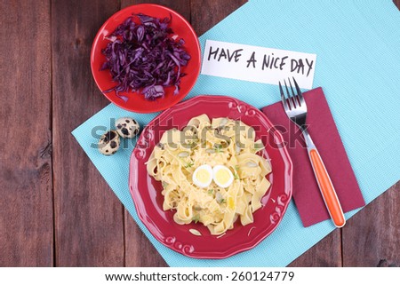 Egg noodles with eggs quail. Italian pasta with cheese and watercress salad. Salad of red cabbage. A delicious and hearty lunch. Tableware, top view.