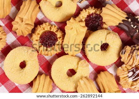 Cookies on the table, top view. Confectionery. Delicious cookies from the dough on a red and white tablecloth. Background, texture of the cookie. A restaurant, a coffee shop, a pastry shop.