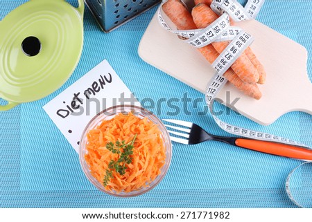 Carrot salad, a bunch of carrots and a cutting board. Diet food, diet plan, diet menu. The concept of diet, diet food. Weight loss, a healthy lifestyle, the concept of healthy eating.