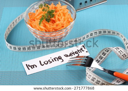 Carrot salad. The concept of weight loss and a healthy diet. I\'m losing weight. Diet food, healthy food. Tasty and healthy. Grated carrots and greens.