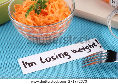 Carrot salad.  I\'m losing weight. Diet food, healthy food. Tasty and healthy. Grated carrots and greens.The concept of weight loss and a healthy diet.