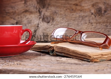 A Cup of coffee. Breakfast. A lover of literature. Reading, Hobbies. Literary criticism, writing. To write books. Search inspiration. Knowledge. Information. Library. Glasses on the book.