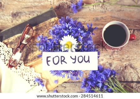 Bouquet of cornflowers and chamomile. Wildflowers in a vase on the table. For you. Surprise, expression of feelings, for a loved one. The manifestation of love and care. Tenderness. Vintage.