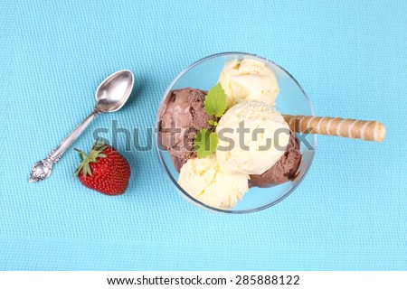 Serving ice cream in a sundae dish. Delicious chocolate-vanilla ice cream. The view from the top. cafeteria, canteen, restaurant. Berry and ice cream. Summer dessert. Strawberries and ice cream.