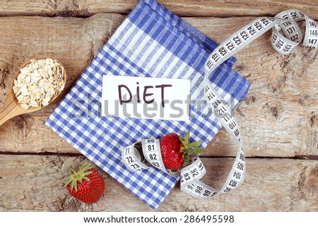 Diet concept. Measuring tape, the concept of losing weight, oatmeal. To lose weight. Checkered napkin, note \