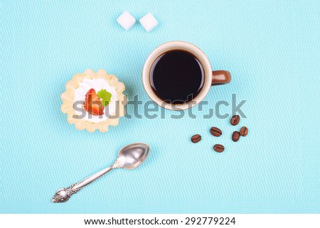 Cup of black coffee, sugar cubes and cake. Strawberry cake with cream. Dessert tart. Cream cake with strawberries, mint leaves. Breakfast, lunch and snack. Cafeteria and restaurant. Food and sweets.
