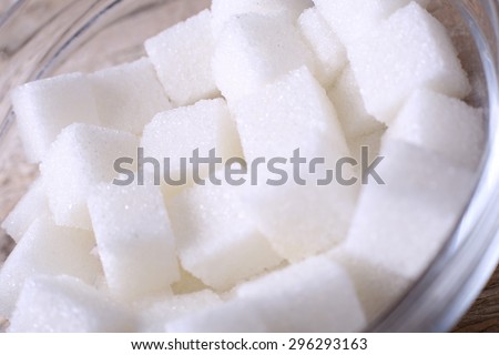 White refined sugar in the sugar bowl. Macro, close-up photography. Cubes of sugar. The crystalline white sugar. Texture, background. Macro sugar. Sugar bowl on the table.