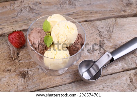 Creamy vanilla and chocolate ice cream. A delicious dessert. Spoon for ice cream. The ice-cream bowls with ice cream. Ripe berry and ice cream. Tasty food, sweet food.