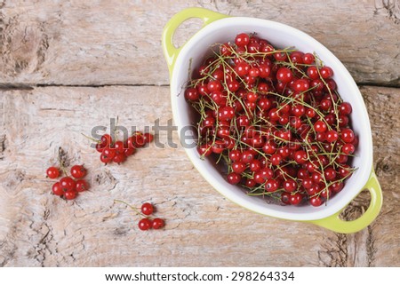 Berries in a bowl, currant. Red currant. Macro photo of berries. Close up. Macro berries. Red berries. Still life. Natural food. Dieting. Wooden table. In the kitchen. Summer berries.