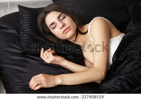 Tranquil sleeping girl. Brunette girl in bed. Girl with eyes closed. Young beautiful woman on the bed. Healthy sleep. Sweet sleep. Deep sleep. Orthopedic mattress. Sweet dreams. Selective focus.