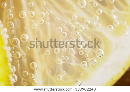 Lemon pulp. Macro, close-up. Lemon slice. Macro photo. Background, texture. Source of vitamin C. Useful properties of a lemon. Sour taste. Lemon and bubbles of carbon dioxide. Lemon in the water.