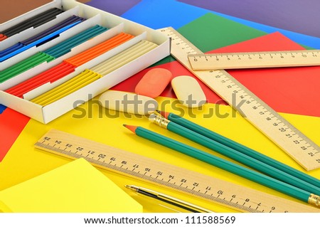 Assorted school supplies - plasticine, pencils, colored paper, rulers, erasers