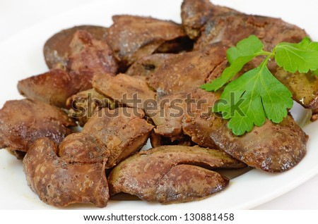 Close up cooked chicken liver on a white plate