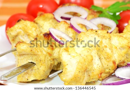 Chicken kebab with vegetables on a plate