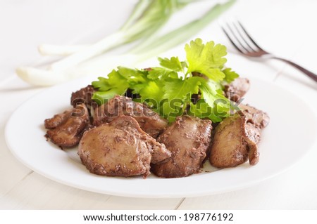 Chicken liver decorated parsley on white plate