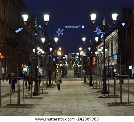 PETERSBURG, RUS-JANUARY 5, 2015:Malaya konyushennaya street in evening illumination. It is pedestrian street with lanterns and statue of writer Nikolai Gogol.  Unidentified people walking along street
