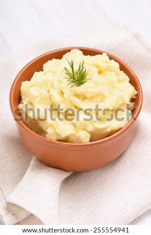 Mashed potato in ceramic bowl, close up view